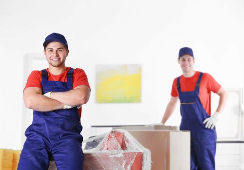 A moving team handling furniture and packed belongings with care