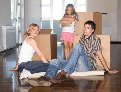 Local moving team handling boxes and furniture in a Kentish Town property